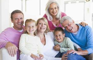 Colorado Springs Crowns Bridges and onlays - family-sitting-indoors-smiling